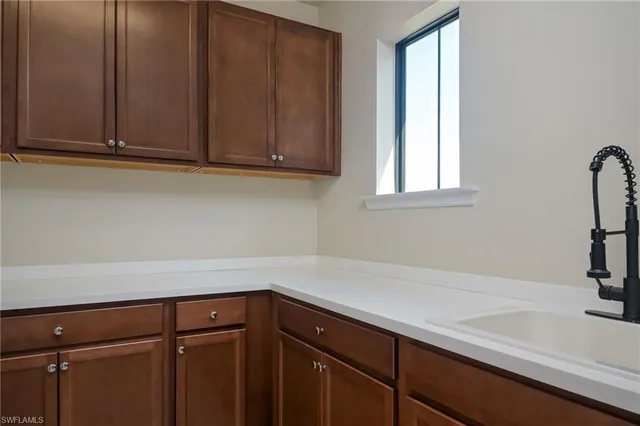 a kitchen with a sink and cabinets