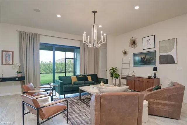 a living room with furniture and a chandelier
