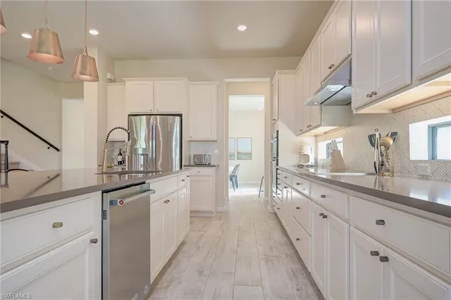 a large kitchen with a lot of counter space and a sink