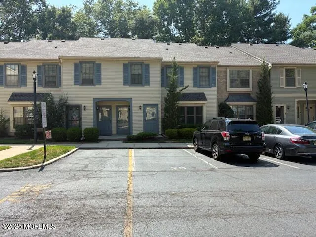 a car parked in front of a white house