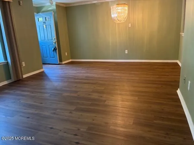 a view of room with window and wooden floor