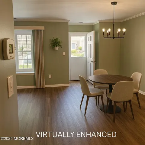 a view of a room with furniture and wooden floor