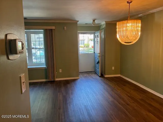 a view of an entryway with wooden floor and a window