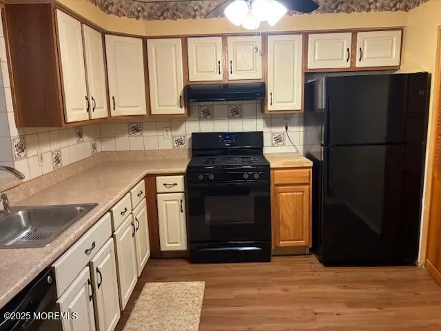 a kitchen with granite countertop a refrigerator stove and sink