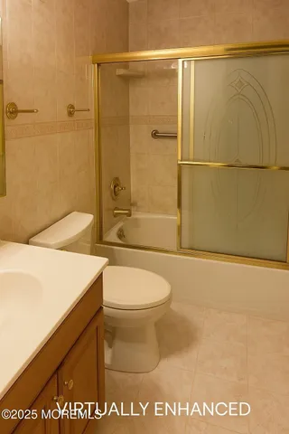 a bathroom with a toilet a sink and shower
