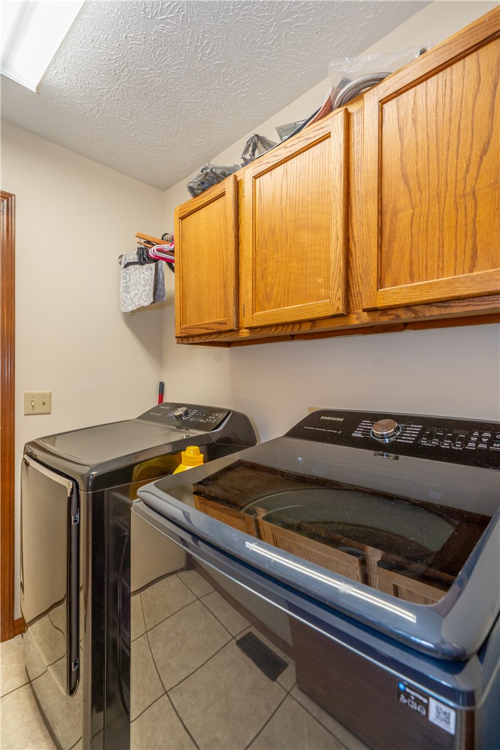 3628 Petre Road Springfield, OH 45502 - Photo 17 of 52 This functional laundry area features modern appliances and practical storage solutions.