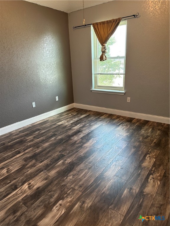 902 Tank Street Copperas Cove, TX 76522 - Photo 20 of 27 an empty room with wooden floor and windows