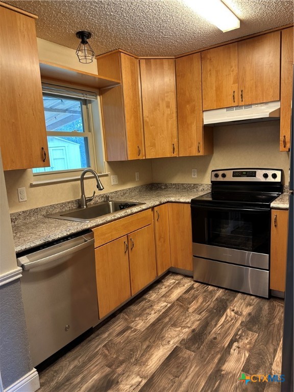 902 Tank Street Copperas Cove, TX 76522 - Photo 6 of 27 a kitchen with stainless steel appliances granite countertop a stove a sink and a microwave