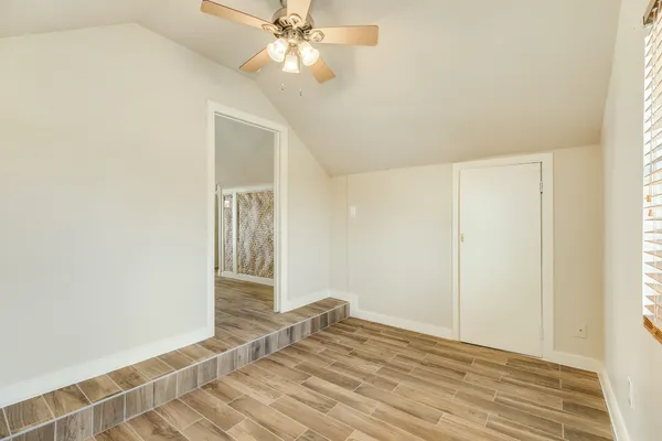 a view of a room with a ceiling fan