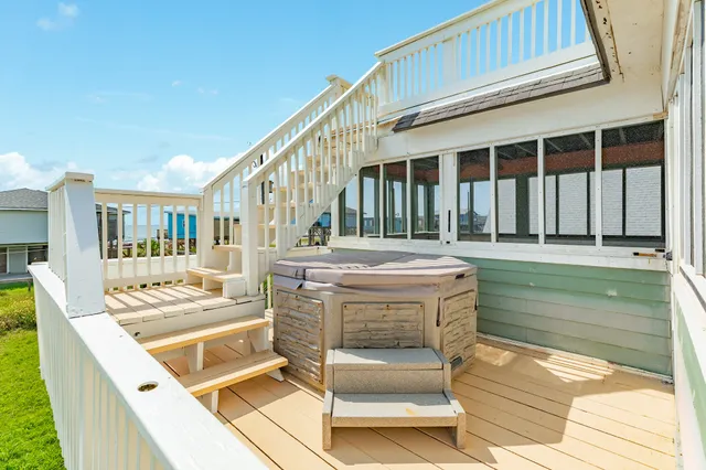 a balcony with table and chairs