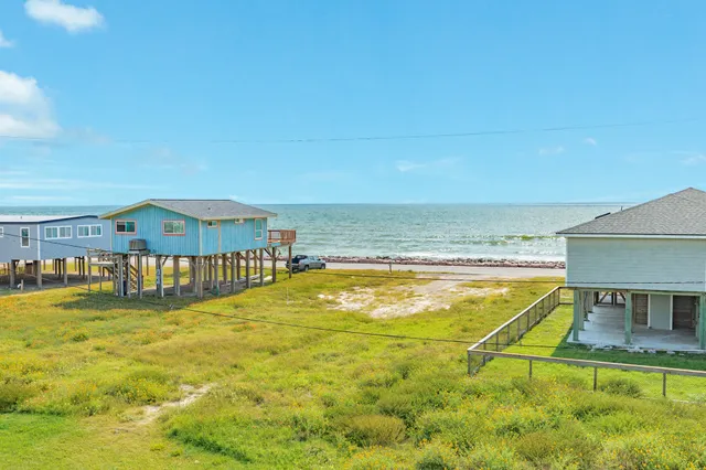 a view of swimming pool with lawn chairs