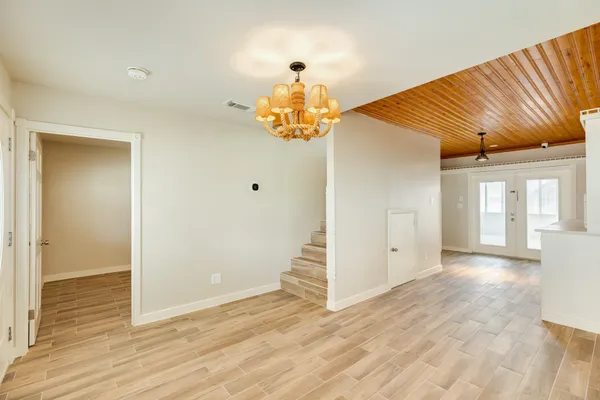 a view of a room with wooden floor