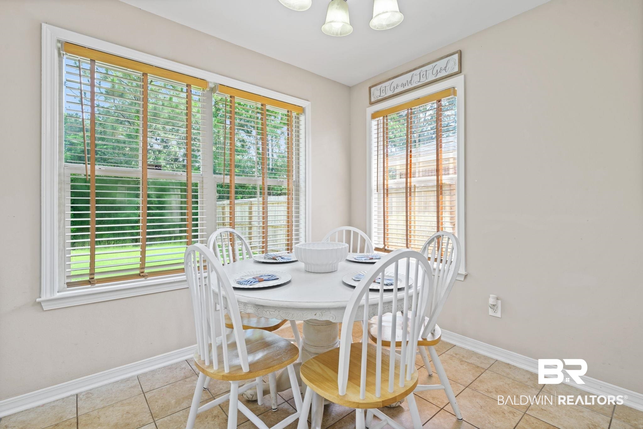 8956 Spring Grove North Mobile, AL 36695 - Photo 7 of 19 Dining room featuring plenty of natural light, baseboards, a chandelier, and light tile patterned floors