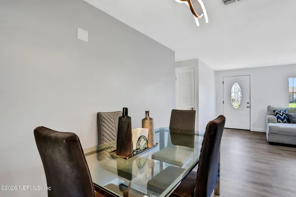 a view of a dining room with furniture and wooden floor