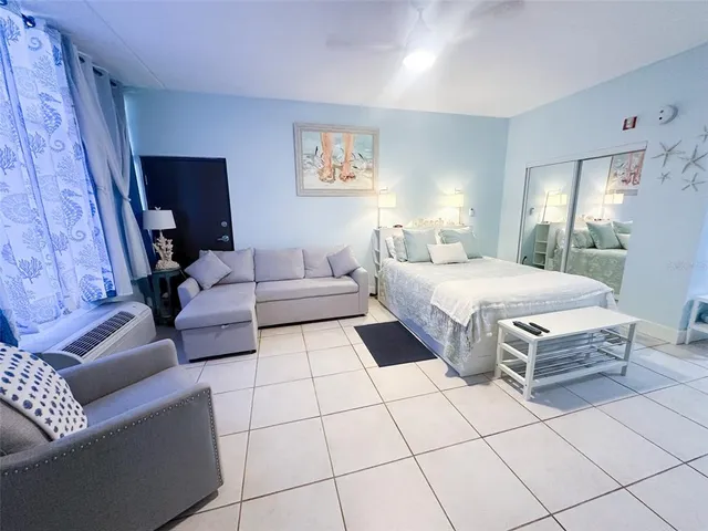 a bedroom with a bed and a couch