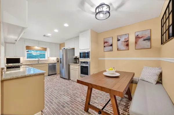 a kitchen with a sink stove and refrigerator