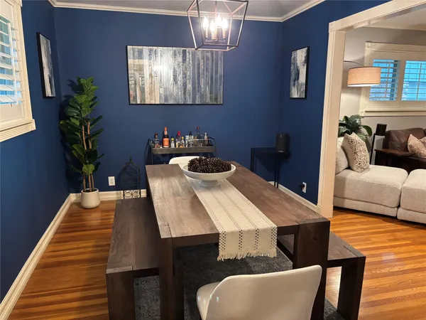 a living room with furniture flat screen tv and window