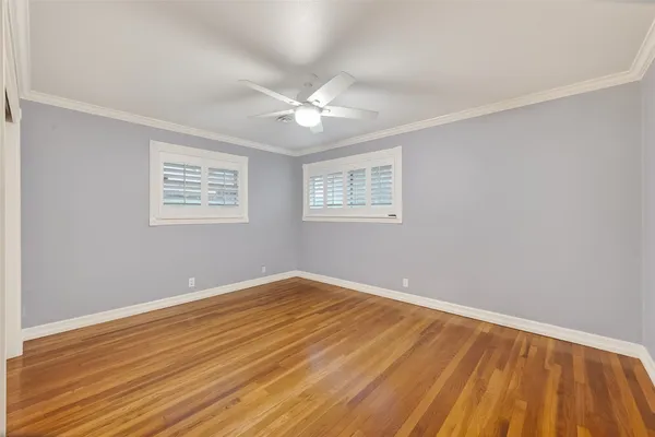 a spacious bedroom with a bed and a flat screen tv