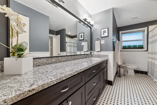 a bedroom with bed and window