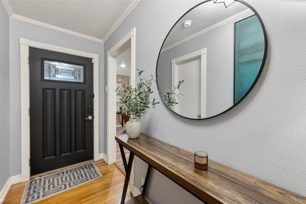 a view of a livingroom with wooden floor and entryway