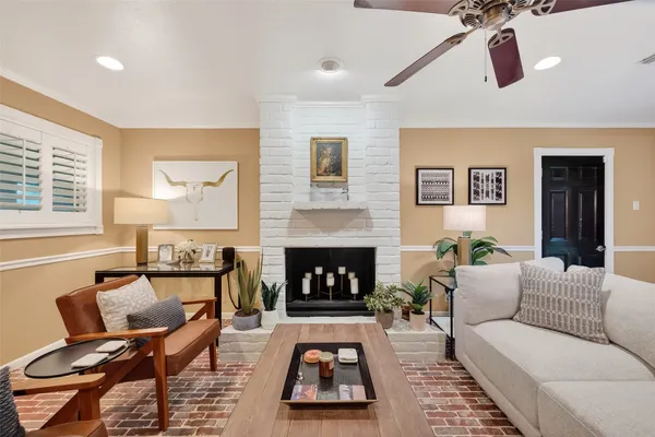a living room with furniture a dining table and wooden floor