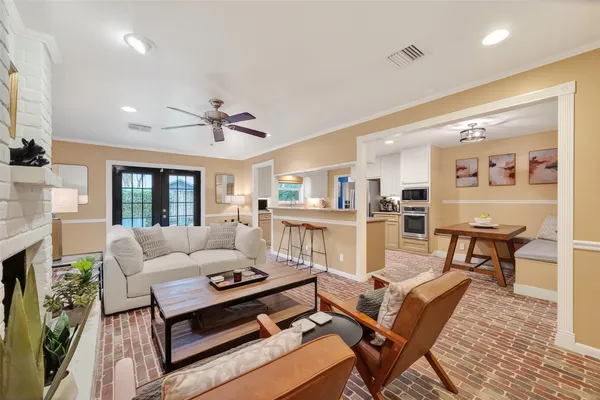 a bathroom with a granite countertop sink a toilet and mirror