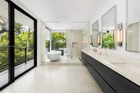 a large bathroom with a large window and sink