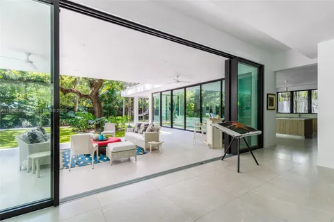 a living room with furniture and a floor to ceiling window