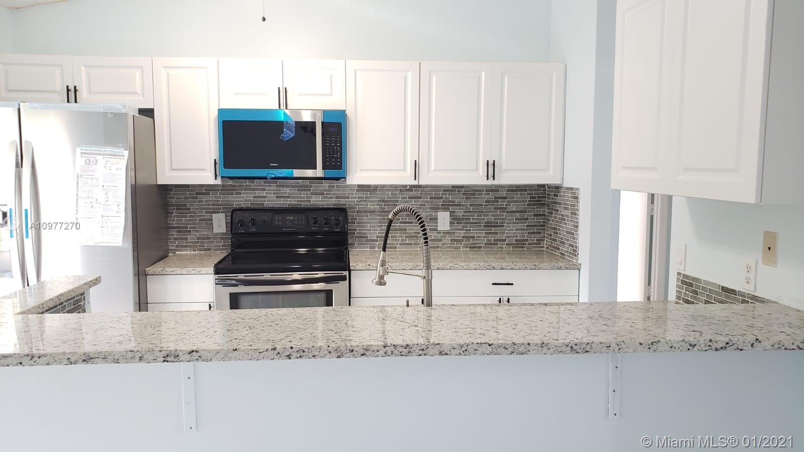 522 Southwest Cherryhill Road Port St. Lucie, FL 34953 - Photo 22 of 49 Kitchen with pass-through opening