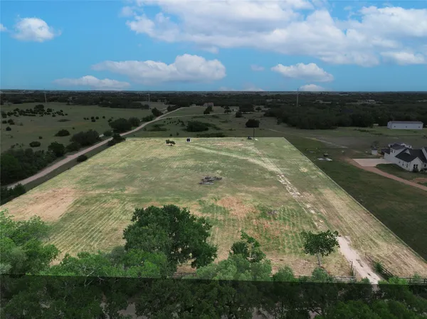 an aerial view of a houses with outdoor space