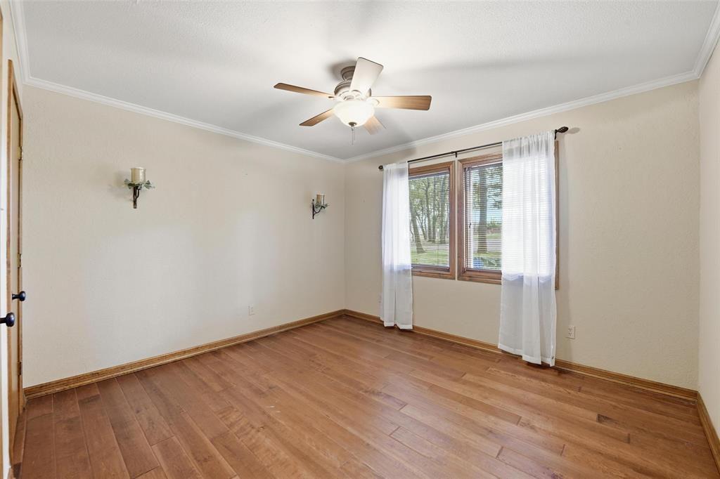 1607 North Main Street Euless, TX 76039 - Photo 15 of 40 a view of an empty room with wooden floor and a window