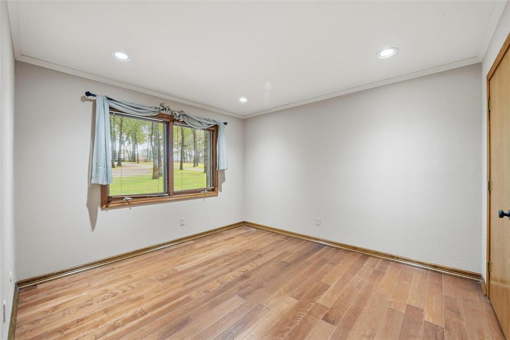 1607 North Main Street Euless, TX 76039 - Photo 16 of 40 a view of an empty room with wooden floor and a window