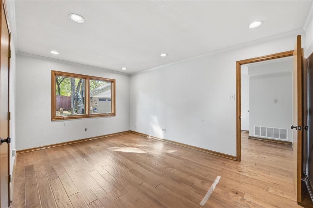 1607 North Main Street Euless, TX 76039 - Photo 17 of 40 an empty room with wooden floor and windows