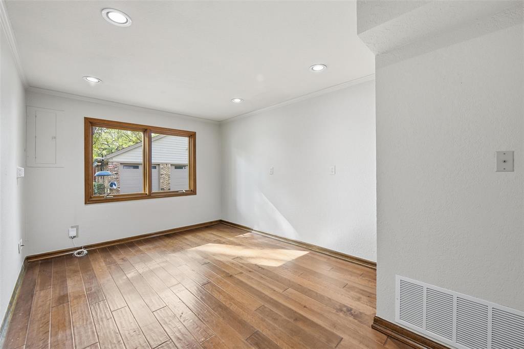 1607 North Main Street Euless, TX 76039 - Photo 20 of 40 an empty room with wooden floor and windows