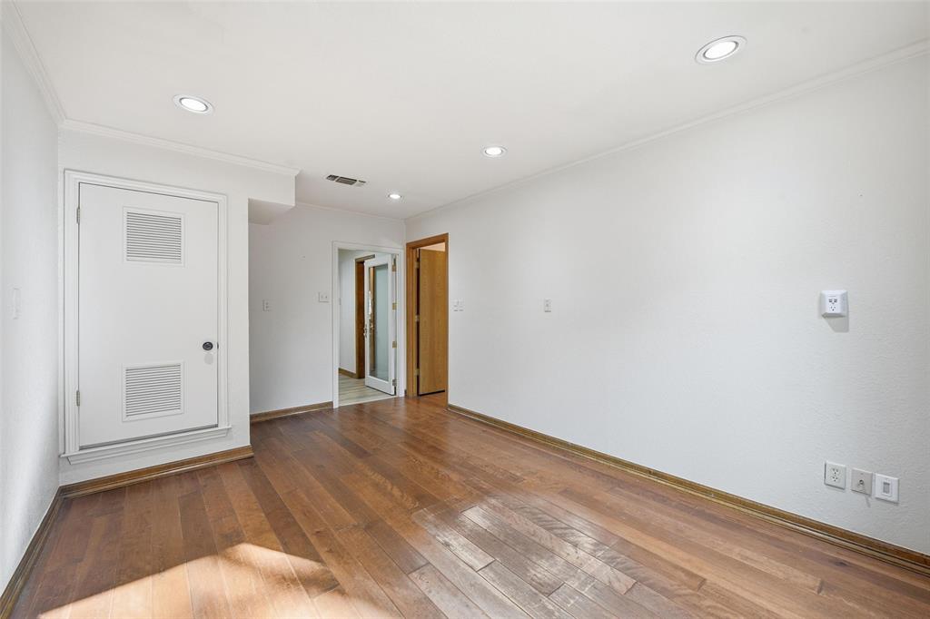 1607 North Main Street Euless, TX 76039 - Photo 21 of 40 a view of an empty room with wooden floor