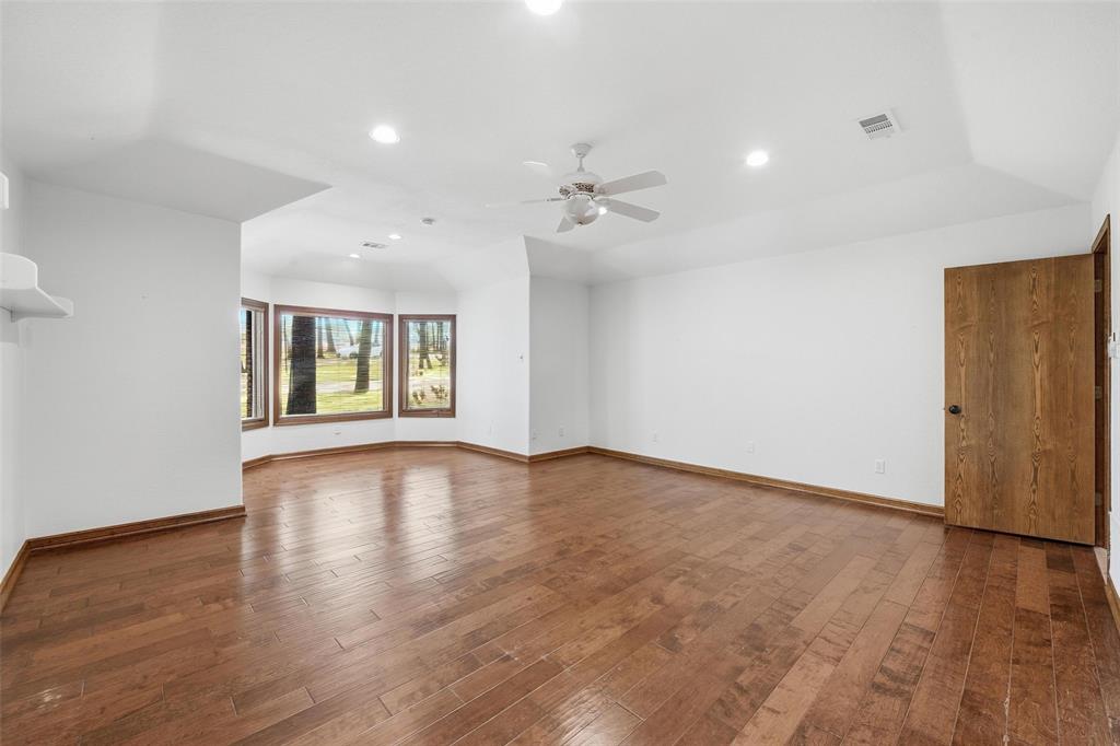 1607 North Main Street Euless, TX 76039 - Photo 26 of 40 a view of an empty room with window and wooden floor