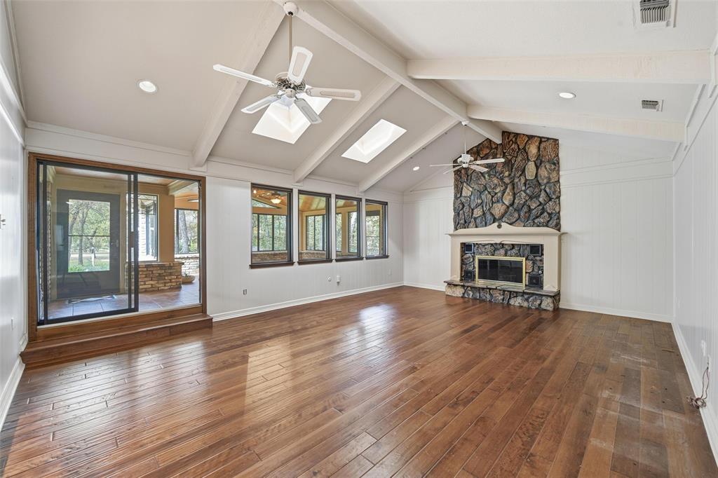 1607 North Main Street Euless, TX 76039 - Photo 35 of 40 an empty room with wooden floor fireplace and windows