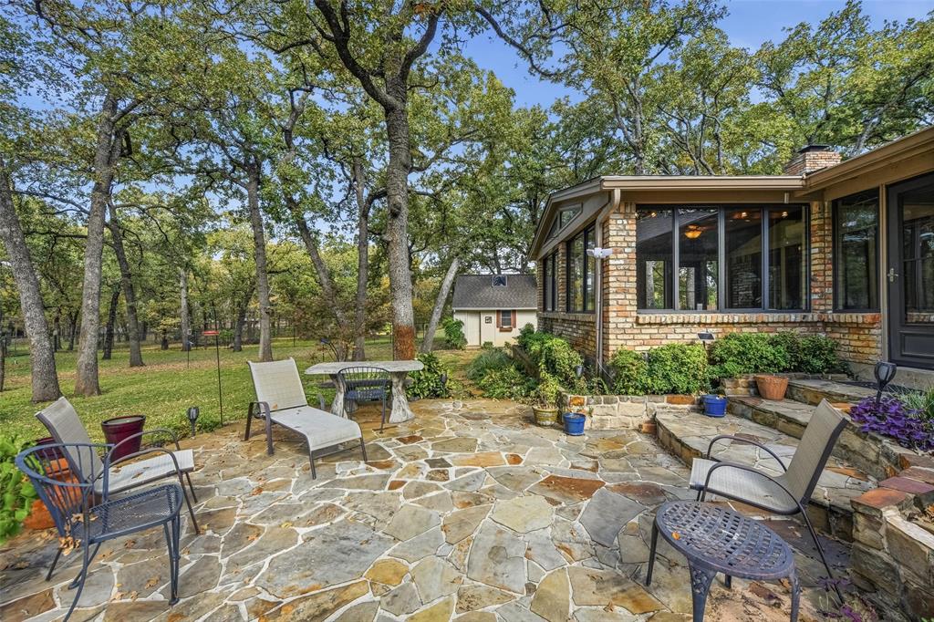 1607 North Main Street Euless, TX 76039 - Photo 6 of 40 a view of a chair and table in backyard of the house