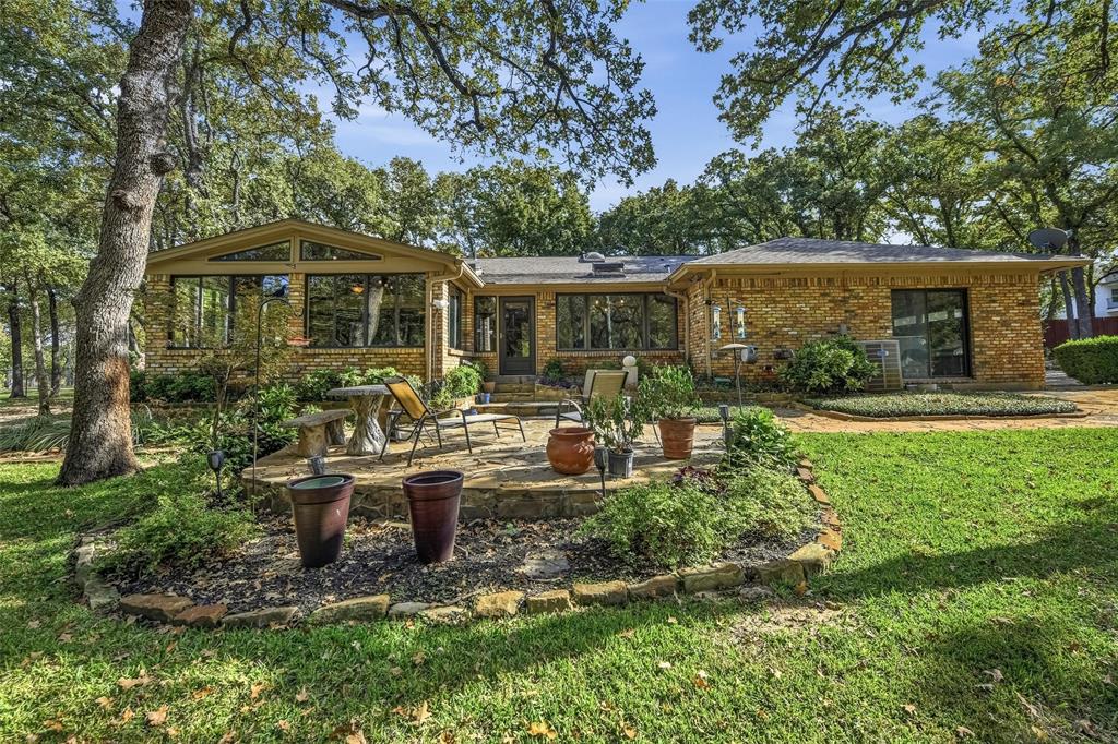 1607 North Main Street Euless, TX 76039 - Photo 8 of 40 a view of a chair and table in backyard of the house