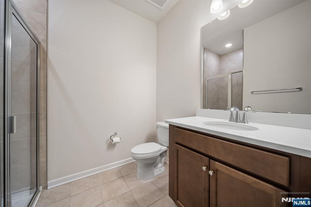 39 Arnold Drive Wood-Ridge, NJ 07075 - Photo 15 of 49 a bathroom with a granite countertop sink a toilet and a mirror