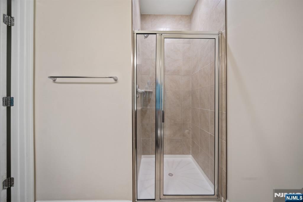 39 Arnold Drive Wood-Ridge, NJ 07075 - Photo 16 of 49 a bathroom with a glass shower door