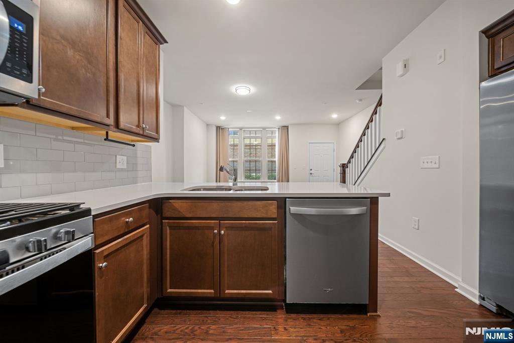 39 Arnold Drive Wood-Ridge, NJ 07075 - Photo 17 of 49 a kitchen with kitchen island granite countertop a sink cabinets and stainless steel appliances