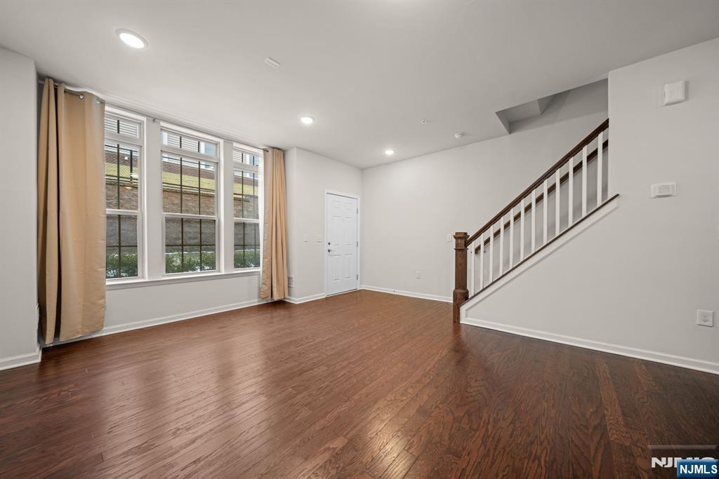 39 Arnold Drive Wood-Ridge, NJ 07075 - Photo 6 of 49 a view of an empty room with wooden floor and a window