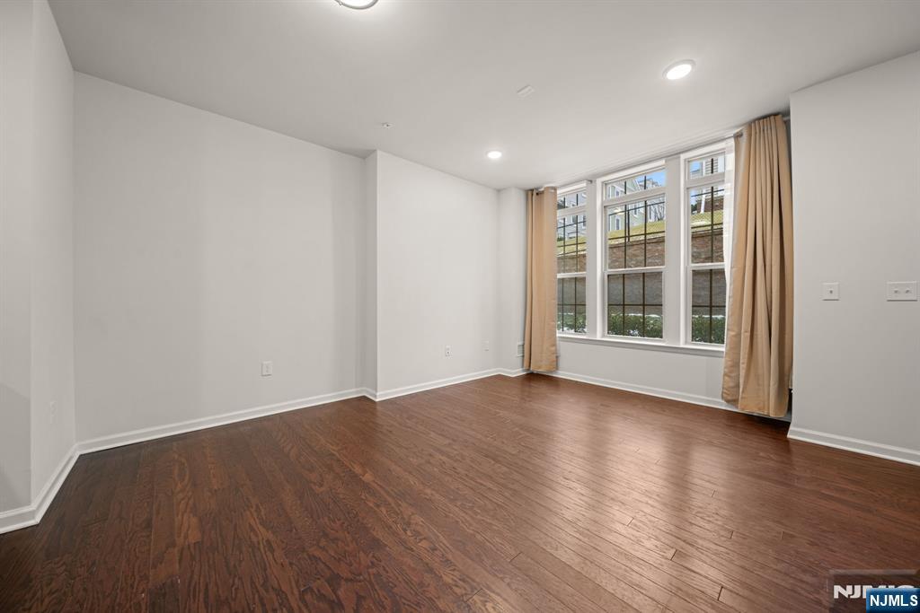 39 Arnold Drive Wood-Ridge, NJ 07075 - Photo 8 of 49 a view of an empty room with wooden floor and windows