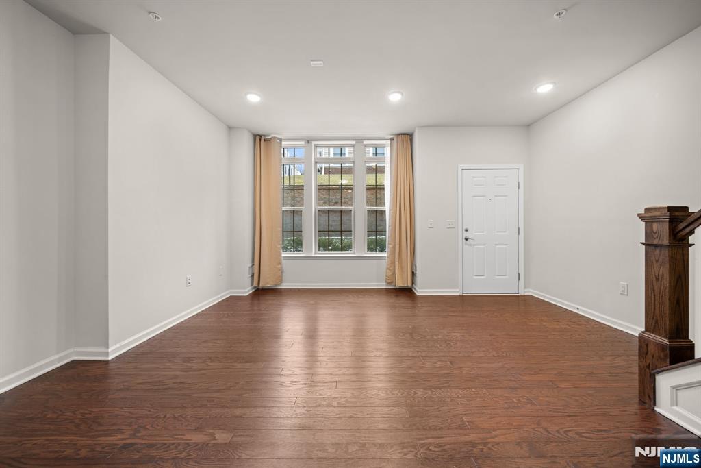 39 Arnold Drive Wood-Ridge, NJ 07075 - Photo 9 of 49 a view of an empty room with wooden floor and a window