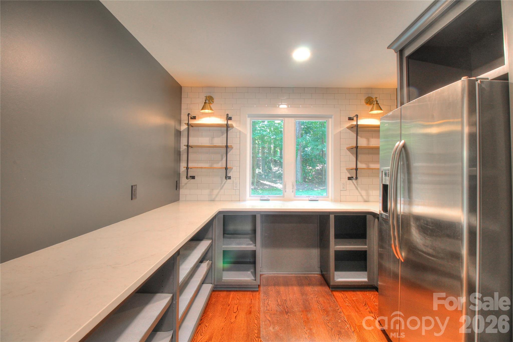 3408 Providence Manor Road Charlotte, NC 28270 - Photo 11 of 39 a kitchen with kitchen island a large counter top space and stainless steel appliances