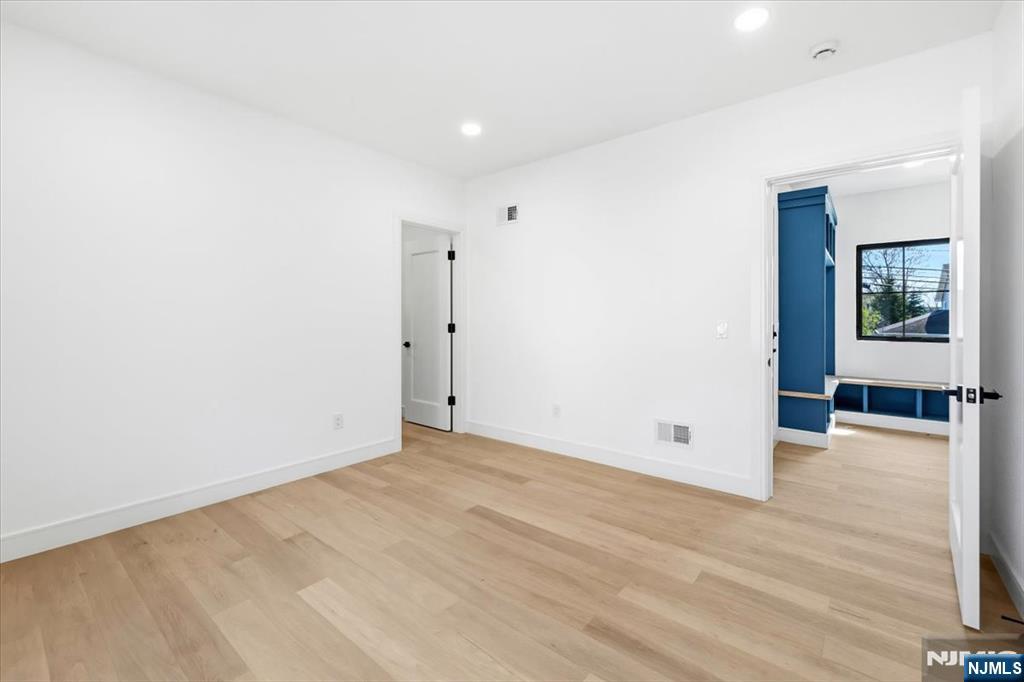 150 Howland Avenue River Edge, NJ 07661 - Photo 34 of 45 an empty room with wooden floor and windows
