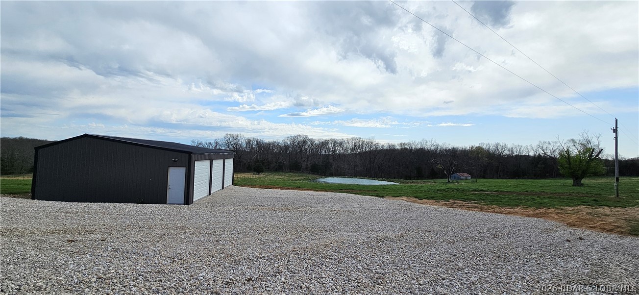 108 Greystone Road Eldon, MO 65026 - Photo 5 of 22 Gravel driveway with a fully fenced in and gated p
