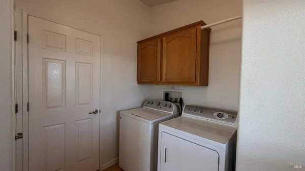 a kitchen with a stove a sink dishwasher and a refrigerator with wooden cabinets
