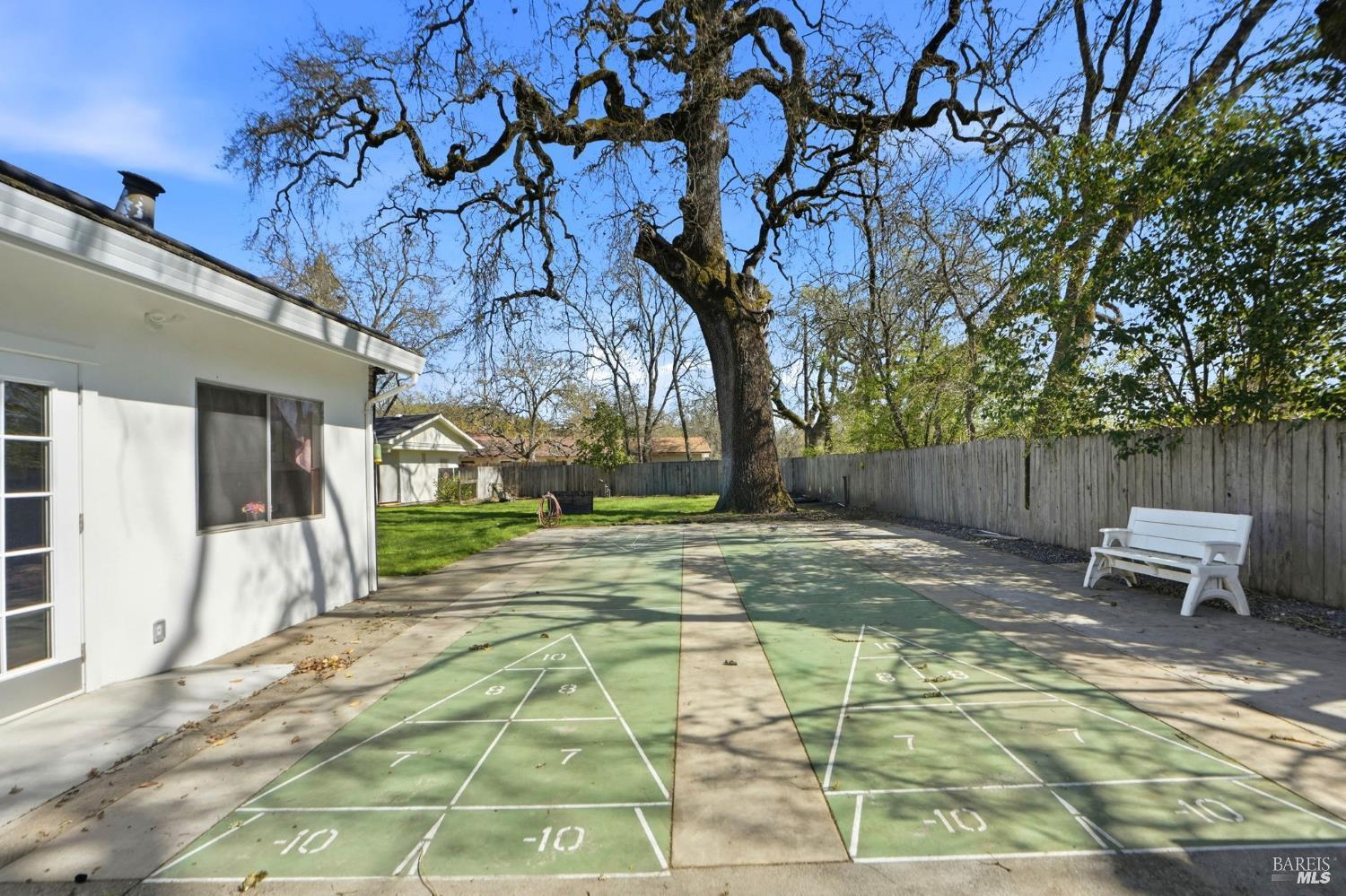 600 Colonial Park Drive Santa Rosa, CA 95403 - Photo 34 of 34 a view of a backyard with table and chairs with wooden fence and plants
